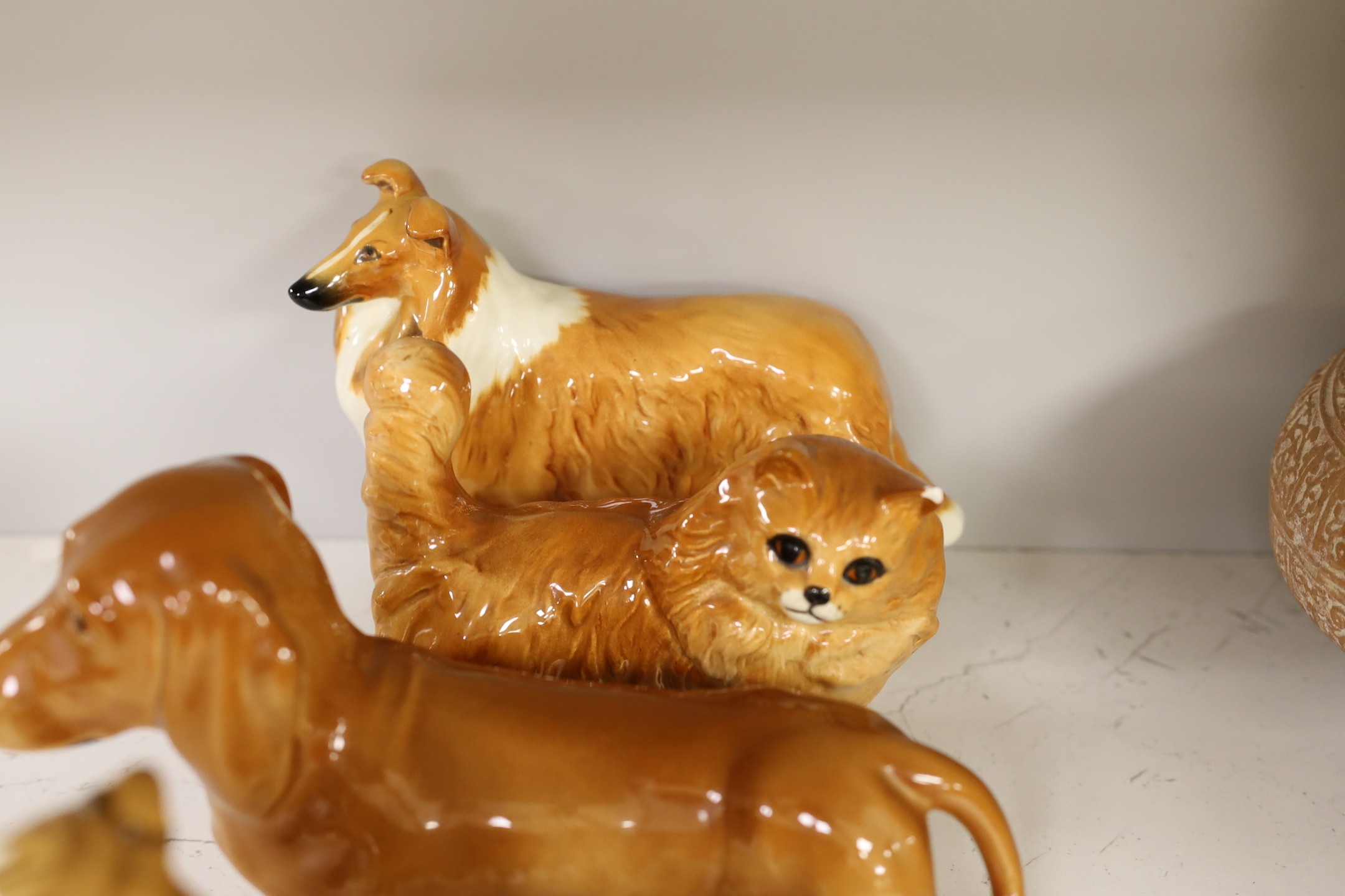 A selection of Beswick dogs, to include a Corgi, Daschund, Lurcher, Beagle, Doberman, Fox Terrier, Lochinvar of Ladypark, together with a Beswick cat (9)